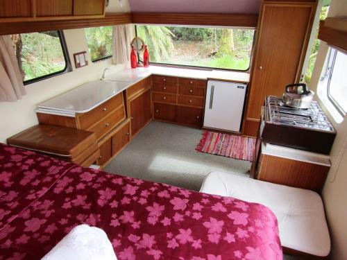 a small kitchen with a sink and a stove at Greenstone Retreat in Kumara