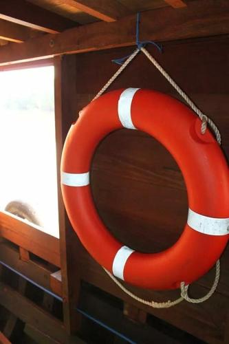 a red and white life preserver hanging on a boat at Orangutan Houseboat Park Tanjung Puting in Pangkalan Bun