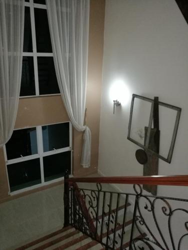 a stairway with a window and a staircase with a light at Guesthouse Dragon Place in Taiping