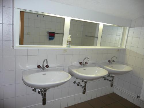 a bathroom with two sinks and a mirror at Haus Eberhard in Vent