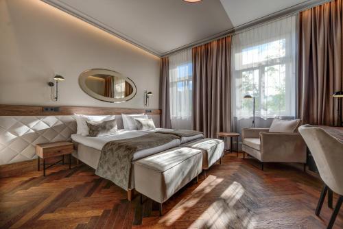 a hotel room with two beds and a mirror at Hotel Vilnia in Vilnius