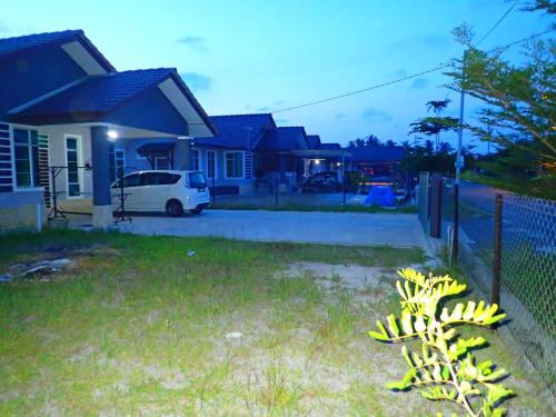 a bunch of bananas in front of a house at RizQin Homestay Bachok in Bachok