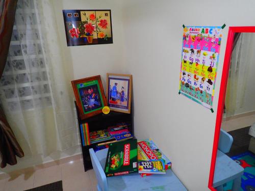a shelf filled with books in a room at RizQin Homestay Bachok in Bachok