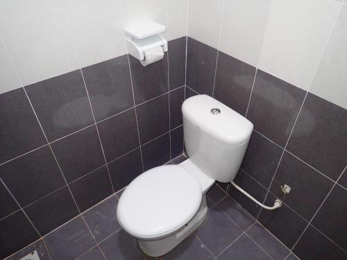 a bathroom with a white toilet in a room at RizQin Homestay Bachok in Bachok