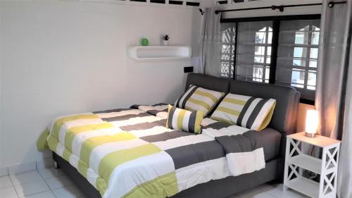 a bedroom with a bed and a window at Sabandy House B&B in Kampung Padang Masirat