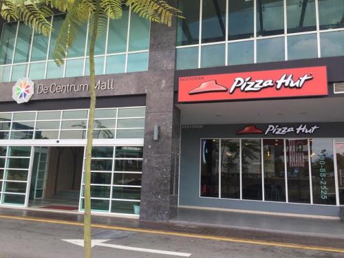 a pizza hut building with a pizza hut sign on it at DeCentrum Residences in Kajang