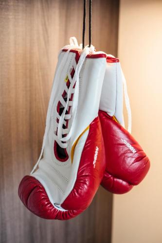 a pair of red and white sneakers hanging from a hook at Star Apart Hotel Sachsenhausen in Frankfurt