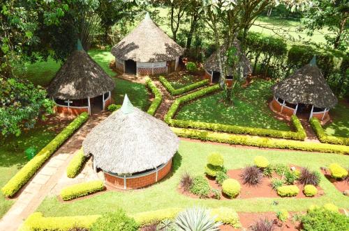 a model of a garden with huts and plants at Golf Hotel Kakamega in Kakamega
