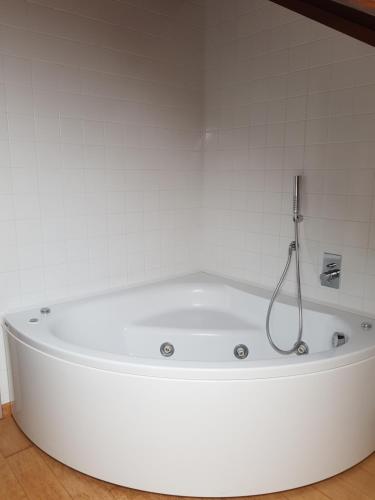 a white bath tub in a white bathroom at La Morona in Rocchetta Tanaro