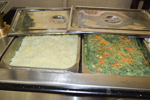 two metal trays of food with rice and carrots at Golf Hotel Kakamega in Kakamega