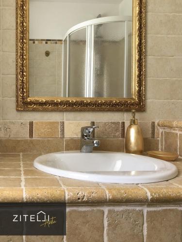 a bathroom sink with a mirror on a counter at Zitelli Aosta in Cogne