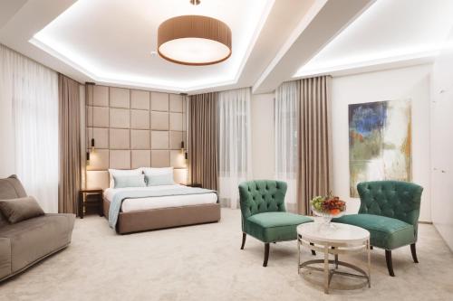 a hotel room with a bed and a couch at Roxen Hotel&Spa in Chişinău