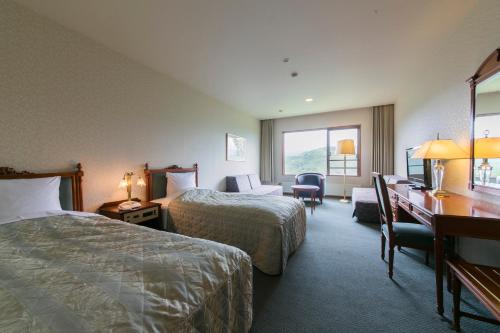 Ένα ή περισσότερα κρεβάτια σε δωμάτιο στο Sky Park Hotel