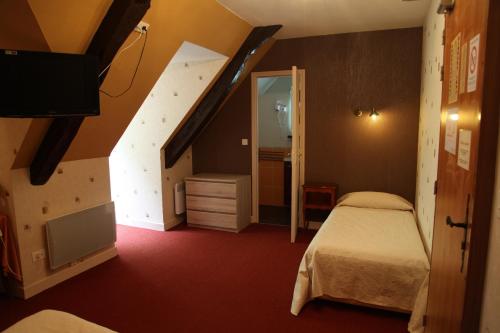 a hotel room with a bed and a staircase at Hotel du Lion d'Or in Rocamadour