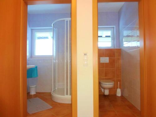 a bathroom with a shower and a toilet at Appartementhaus Monika in Flattach