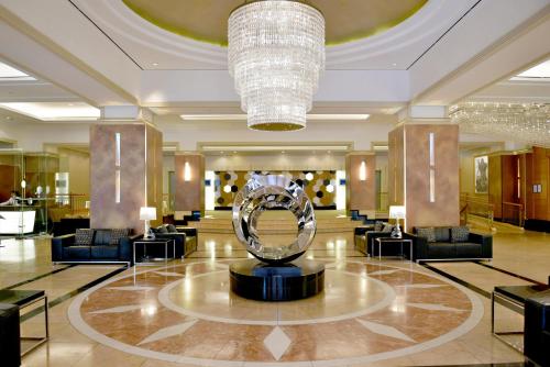 a lobby with a large silver sculpture in the middle at Duxton Hotel Perth in Perth