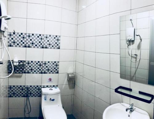 a bathroom with a toilet and a sink at LunaStay (Shared Common Area) in Lunas