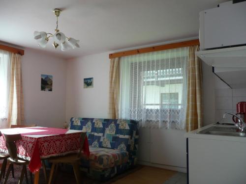 a living room with a table and a chair and a kitchen at Haus Eberhard in Vent
