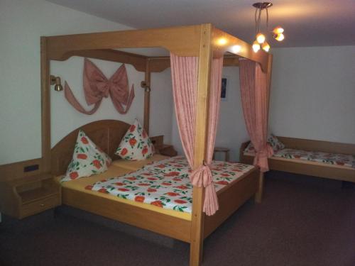 a bedroom with a bunk bed with a canopy at Moselhotel Waldeck in Burgen