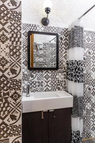 a bathroom with a sink and a mirror at Emmanuel Apartments in Rhodes Town