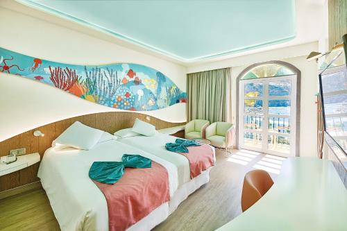 a hotel room with a large bed and a window at Hotel LIVVO Puerto de Mogán in Puerto de Mogán