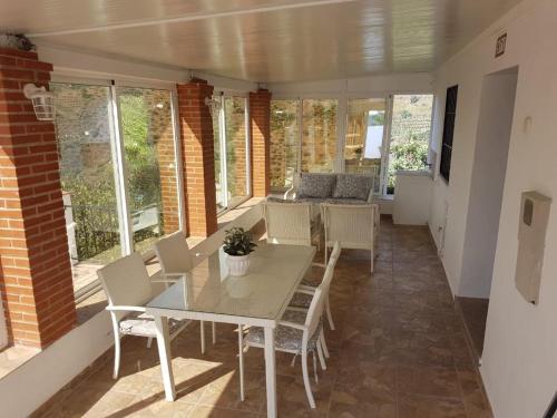 a dining room with a table and chairs at Casa Algill in Torrox