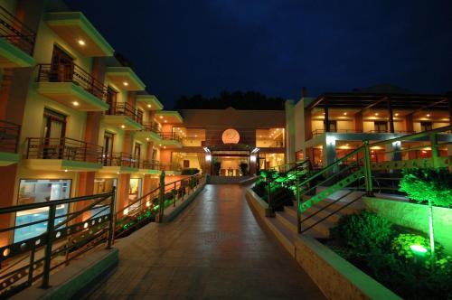 an empty hallway of a building at night at 4 Epoxes Hotel Spa in Kato Loutraki