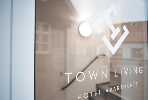 a window with the ox wow living logo on it at Hotel Town Living in Ringkøbing