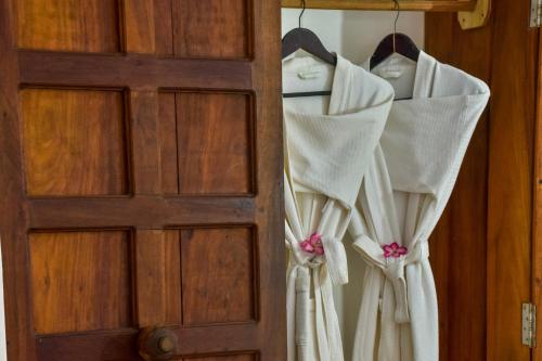 a door with white curtains hanging from it at Kena Beach Hotel in Matemwe