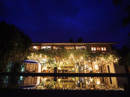 a building with christmas lights on it at night at Saffron & Blue in Bentota