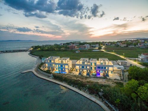 an aerial view of a group of houses next to the water at Villa Miri in Privlaka