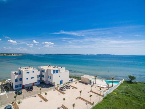 an aerial view of a building and the ocean at Villa Miri in Privlaka