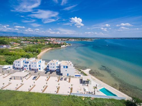 an aerial view of a beach with white buildings and the water at Villa Miri in Privlaka