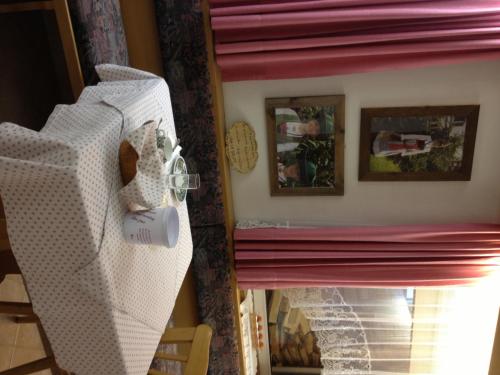 a room with a bed and a fireplace at Garni Sayonara in Selva di Val Gardena