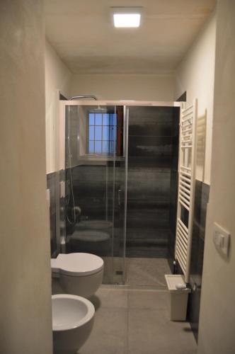 a bathroom with a shower and a toilet and a sink at Lucernaio Rooms in Ragusa