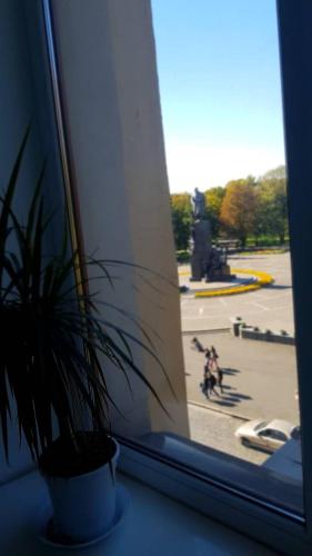 a potted plant sitting on a window sill with a view at Apartment on Sumskaya 46 "Central Residence" in Kharkiv