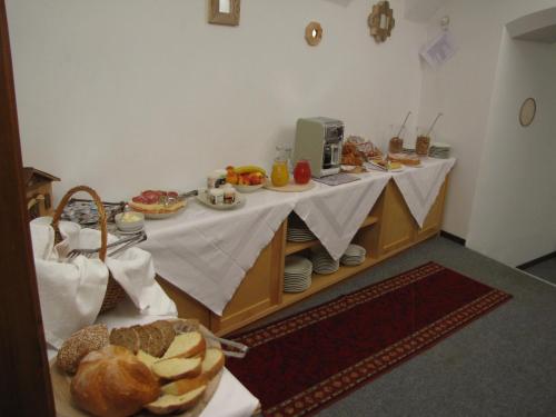 a table with food on it in a room at La Molinela B&B in Folgaria