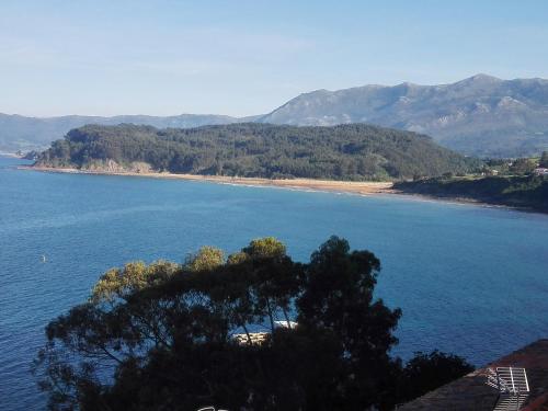 an island in the middle of a large body of water at El Trasgu in Lastres