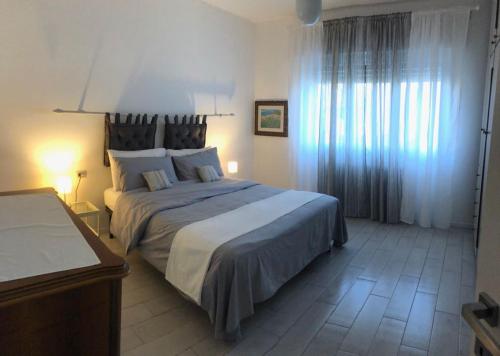 a bedroom with a large bed in a room at Villa Marisa in Nebbiuno