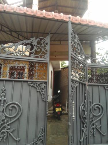 an entrance to a house with an iron gate at Colombo 20 minutes by train in Wattala