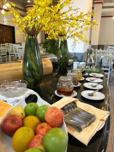 a table with a bunch of fruit on it at Hotel Al Madinah Holiday in Muscat
