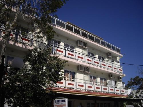 a white building with balconies on the side of it at Bristol Apartments in Kos