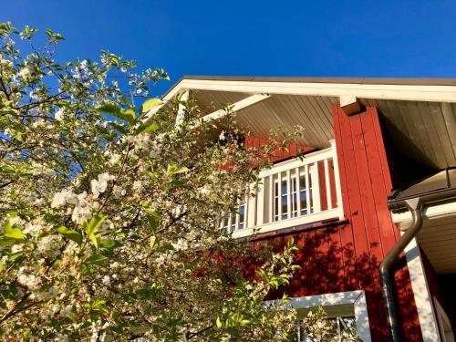 a red house with a window and a tree at Villa Sofia Boutique Trakai in Trakai
