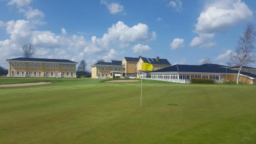 a golf course with a green and a building at Melleruds Golfklubb Bed & Breakfast in Mellerud