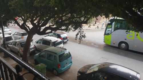 a group of cars parked on a street with a bus at Le Stelle del Massimo in Palermo