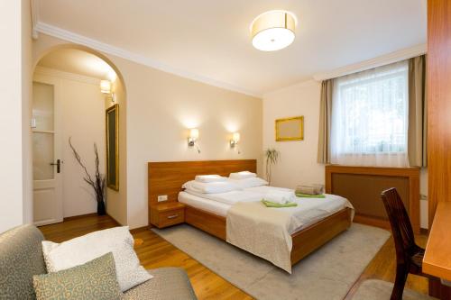 a hotel room with a bed and a couch at CityPark Villa Flat in Budapest