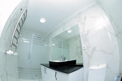 a bathroom with a sink and a mirror at Apartment on Registon Kochasi in Samarkand