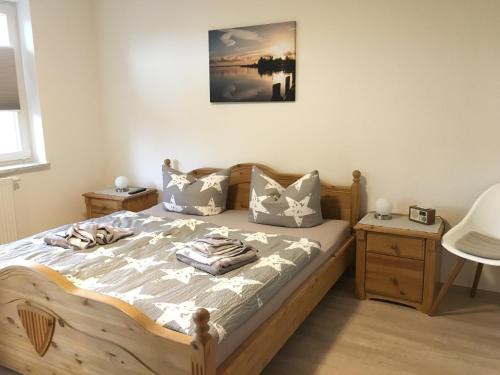 a bedroom with a wooden bed with pillows on it at Haus Hugo Zingst in Zingst