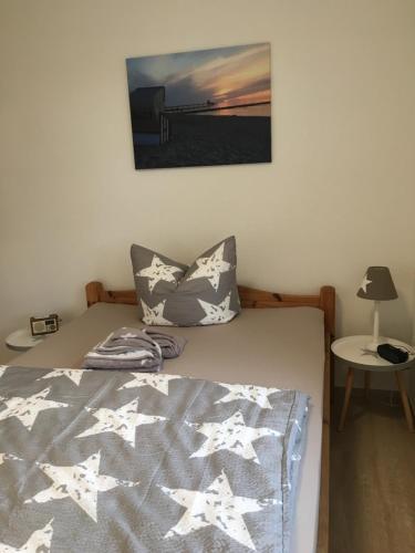 a bedroom with a bed with stars on it at Haus Hugo Zingst in Zingst