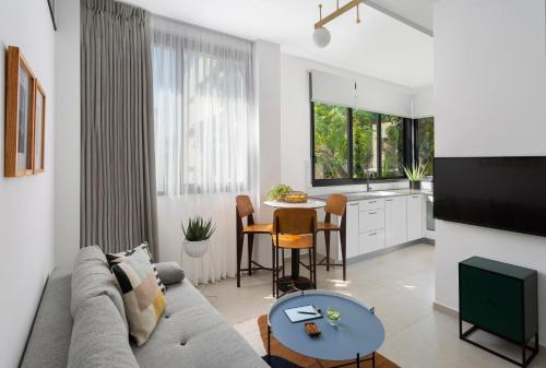 a living room with a couch and a table at Mr. Ben Yehuda - By TLV2GO in Tel Aviv